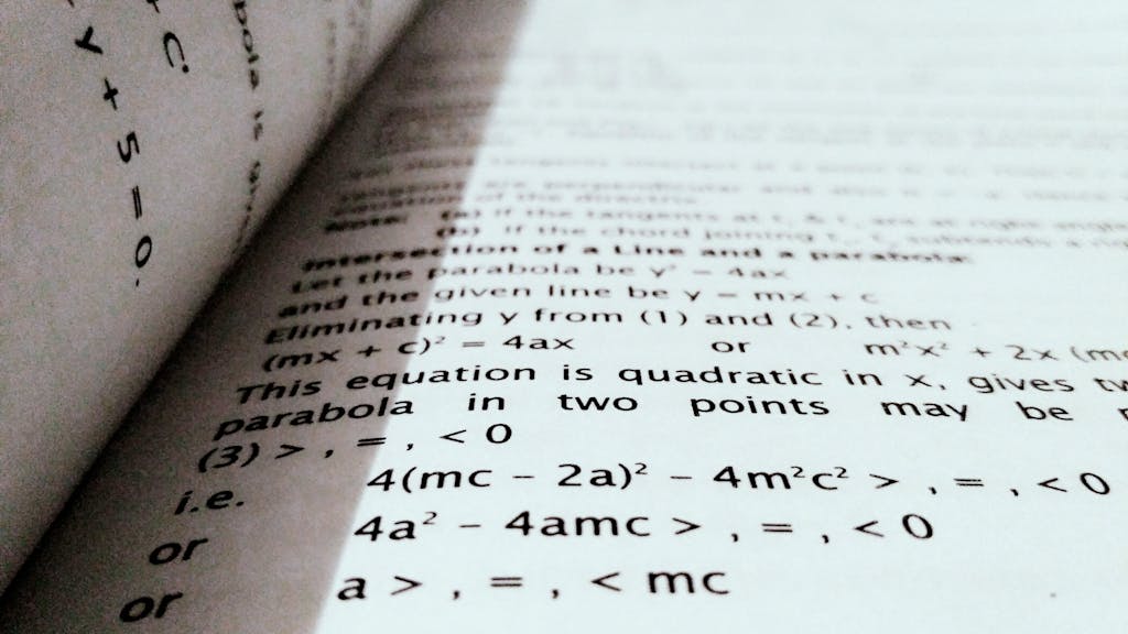 A close-up shot of mathematical equations on a book page, perfect for education and learning concepts.
